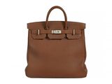 a brown leather handbag on a white background