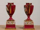 two vases that are sitting on a table