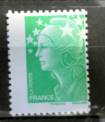 the stamp is green and white with a woman ' s face on it