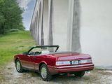 a red convertible car parked on the side of the road
