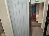 a refrigerator that is in the corner of a room