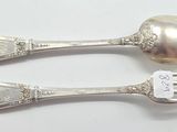 pair of silver plated spoons and a fork with a tag on it