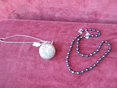 necklace and earring set with silver plated pendant on pink velvet