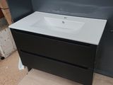 a white sink and a black cabinet in a bathroom
