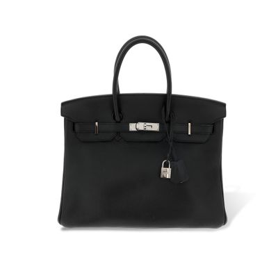 a black leather handbag on a white background