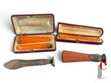 three different types of knives in a case on a white surface