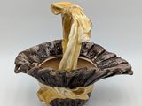 a small bowl with a banana in it