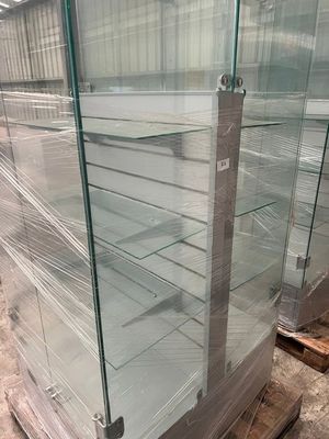 a glass display case in the middle of a warehouse