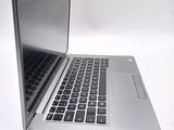 a silver laptop computer sitting on top of a white table