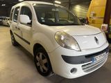the small white van is parked in a garage with other cars