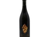 a bottle of wine with a gold leaf on it