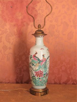 a lamp that is sitting on a table in front of a wall