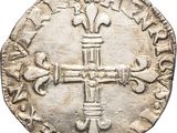 an old silver coin with a cross on it
