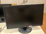 a computer monitor sitting on top of a desk