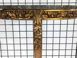 an ornately carved console table with a marble top and gold leaf decoration