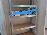 a shelf that has a blue tape on it