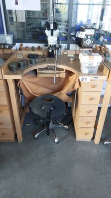a desk with a chair and a mirror in the room