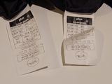 two tickets on a table with a pair of umbrellas
