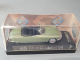 a green toy car in a clear box on a table