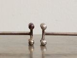 a metal rack that has a bunch of hooks on it