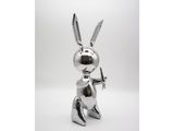 silver metal sculpture of a rabbit with a gun in its hand