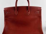 a brown leather handbag sitting on top of a white table