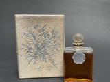 an image of a bottle of perfume next to a box