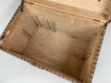 an old suitcase that is open on a white surface