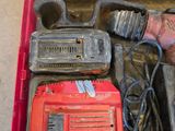 a red tool box with tools in it on the floor