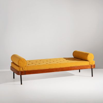 an image of a yellow day bed with a wooden frame