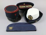 three hats and a hat case sitting on a table