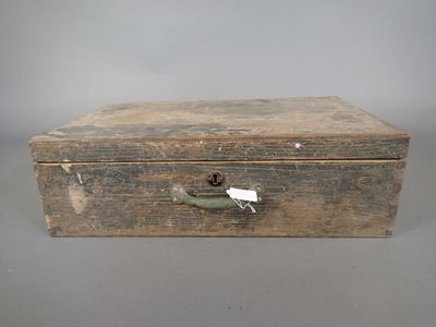 an old wooden box with a handle and a tag on it