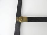 a close up of a metal object on a white surface