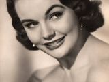 an old black and white photo of a woman in a strapless dress