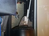 an image of a black punching bag in a garage