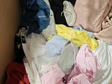 a box full of clothes that is sitting on the floor