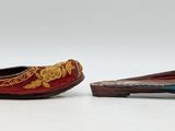 two pairs of shoes that are sitting on a white surface