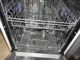 a dishwasher with many dishes inside of it