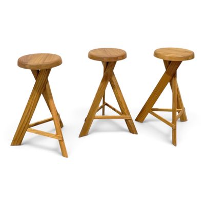 a set of three stools with wooden legs on a white background
