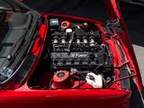 a red car with an engine in the trunk