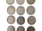 an image of a group of six different coins on a white surface