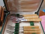 a suitcase with a bunch of utensils inside of it