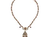 a close up of a necklace on a white background