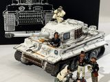 a small toy tank with soldiers on it next to a box