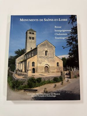 the front cover of a book with a church in the background