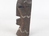 an image of a wooden sculpture of a face on a white background