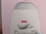 someone is holding a hello kitty lamp in their hand