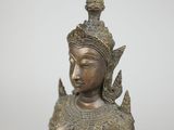 a bronze statue of a woman with a bird on her arm