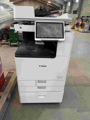 a printer that is sitting on a pallet in a warehouse