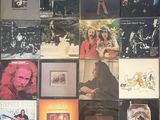 many different album covers on the wall of this room